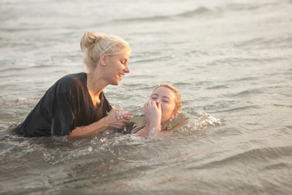 Young woman baptized in the ocean